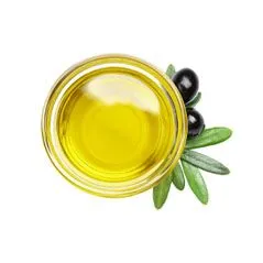 Small bowl of olive oil surrounded by olive